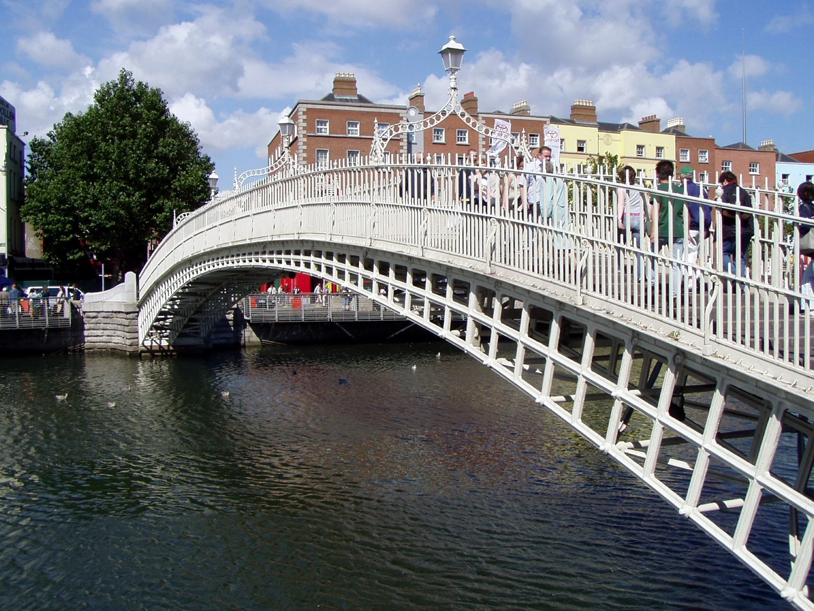 Ha’penny Bridge over the River Liffey in Dublin, with the riverside buildings beyond